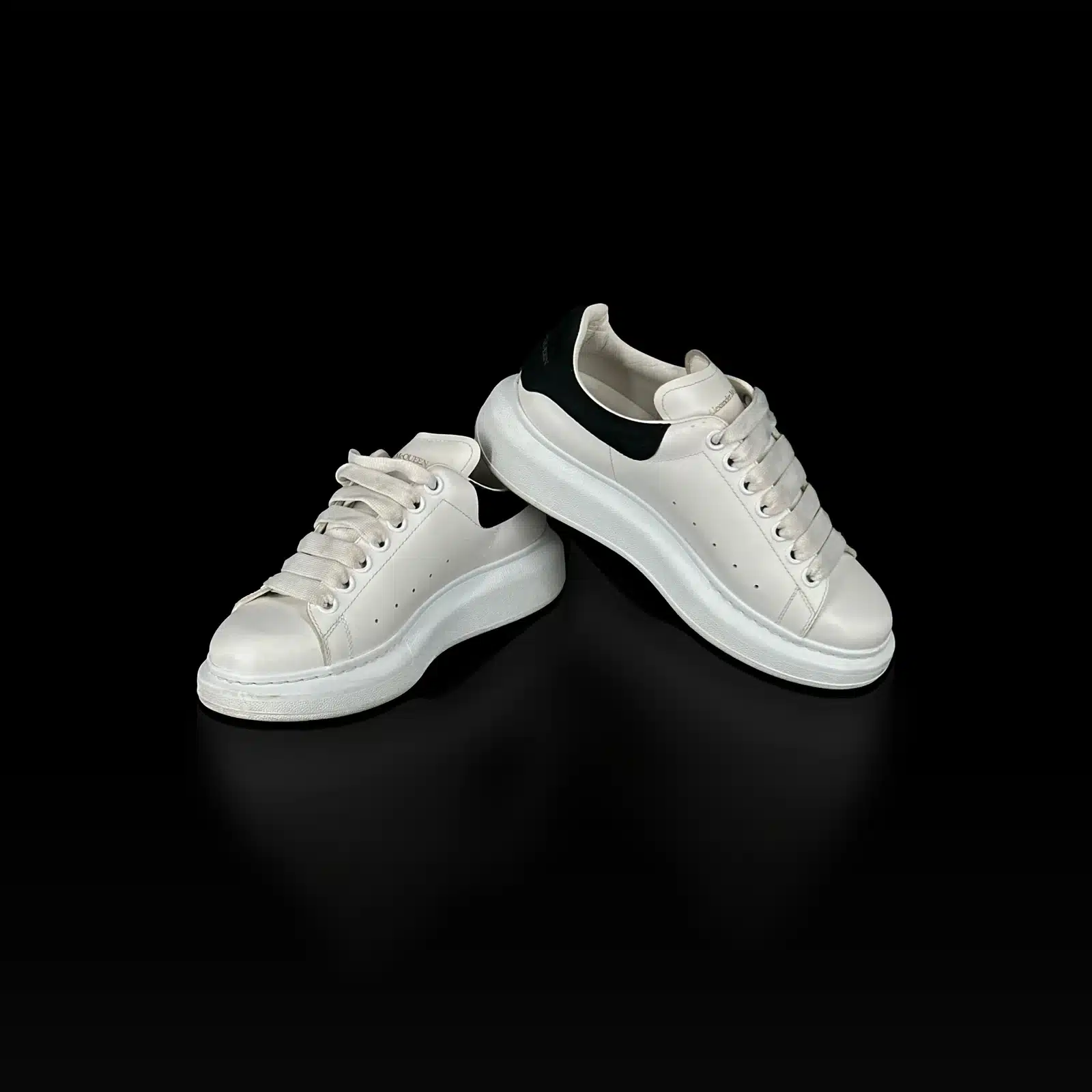 Paire de baskets Alexander McQueen Oversized blanc et noir, vue de profil croisée