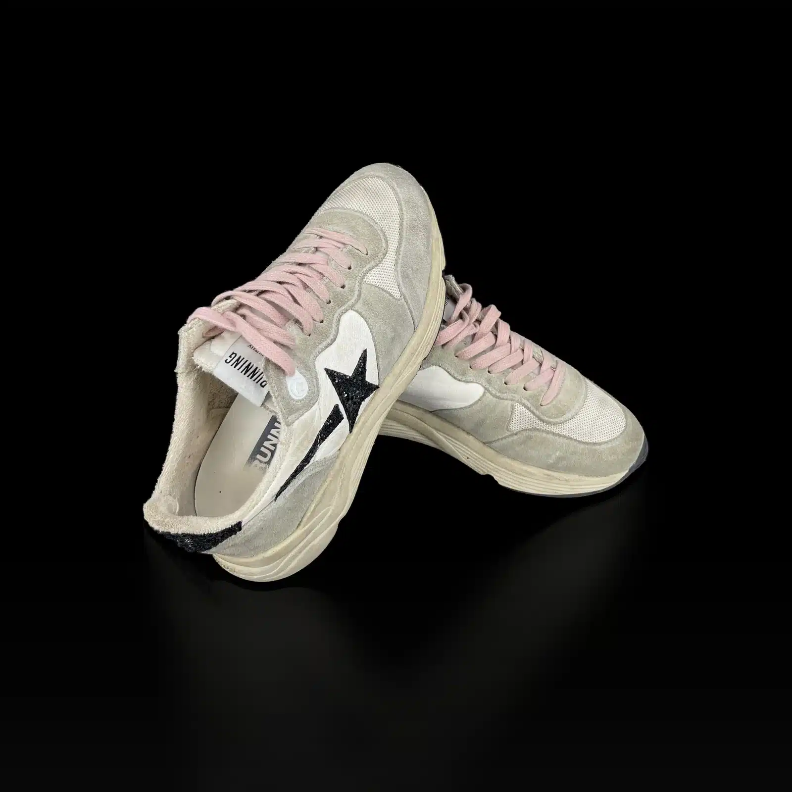 Crossed pair of Golden Goose Running Sole sneakers, Running tag and black star