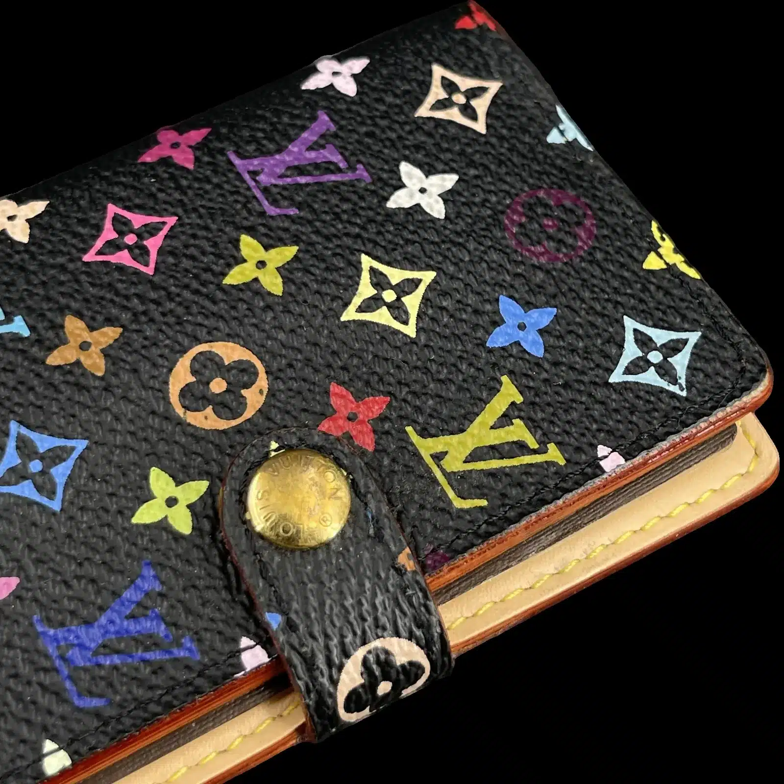 Détail de la toile Monogram Multicolore et du bouton pression doré du Carnet de Bal Louis Vuitton